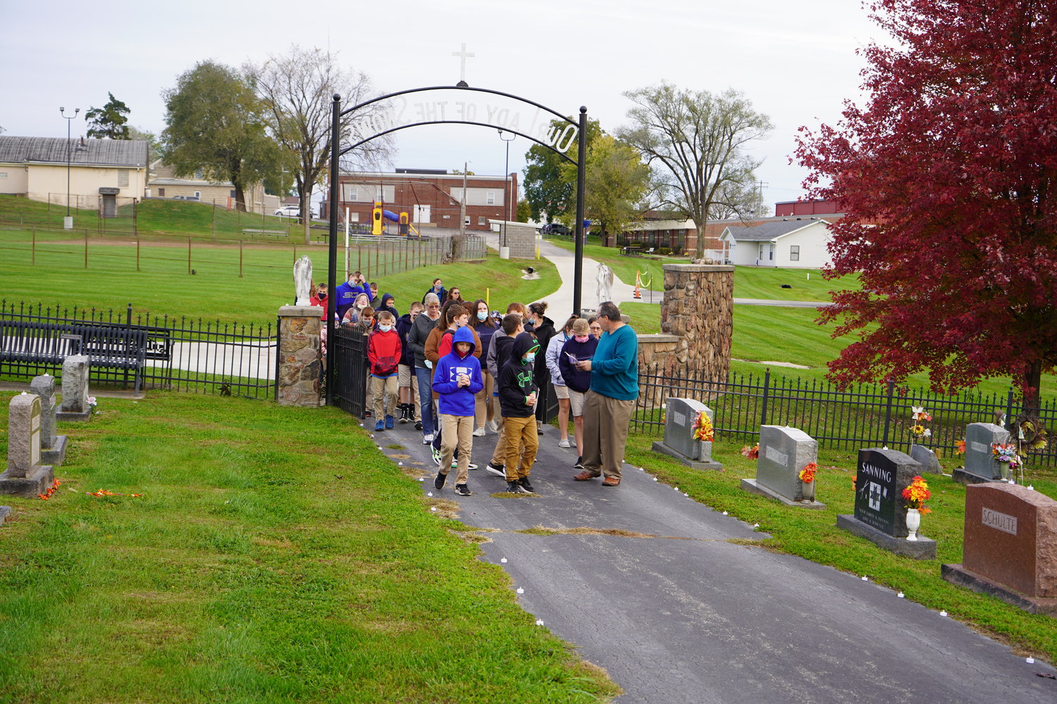 Students of Our Lady of the Snows School pray for the faithful departed in their parish cemetery Nov. 2.